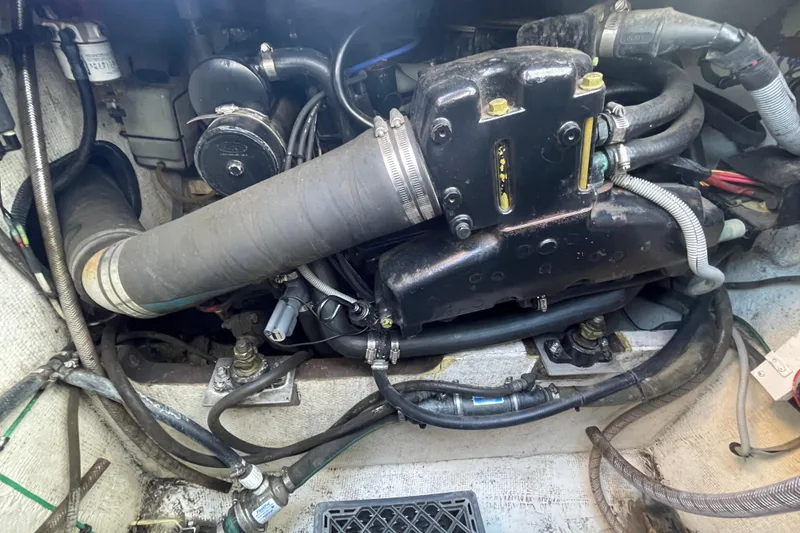 Slide: The Image of Engine compartment of a 1987 Bertram 28 Sport Fisherman boat, showing hoses and components. - 37