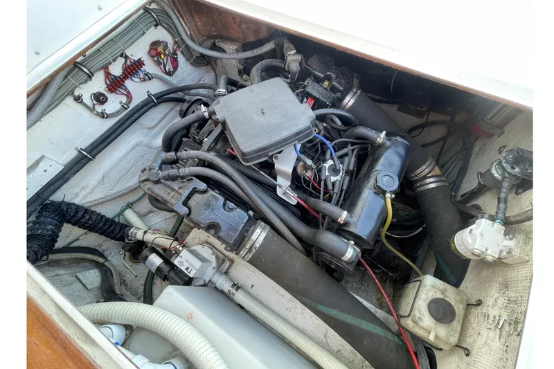 Slide: The Image of Engine compartment of a 1987 Bertram 28 Sport Fisherman boat, showcasing detailed wiring and components. - 38