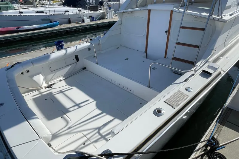 Slide: The Image of 1987 Bertram 28 Flybridge boat with spacious deck, docked at marina. - 5