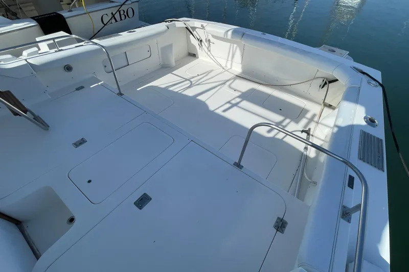 Slide: The Image of 1987 Bertram 28 Flybridge boat deck, spacious and well-maintained, docked at marina. - 8