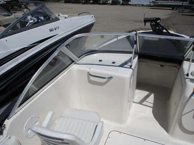Slide: The Image of Interior of a 2005 Sea Hunt 186 Escape boat, white seating and helm area. - 6