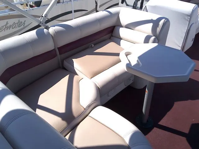 Slide: The Image of Interior of a 2002 Godfrey 240 FISH AND FAMILY boat with seating area. - 13
