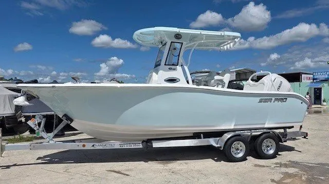 The Image of 2026 Sea Pro 245FLX boat on trailer under sunny skies. - 1