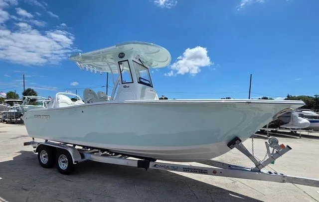 Slide: The Image of 2026 Sea Pro 245FLX boat on trailer under blue sky. - 2