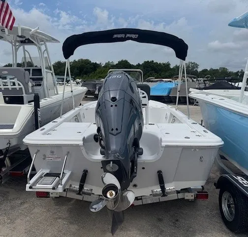 Slide: The Image of 2026 Sea Pro 210DLX boat with outboard motor, on a trailer. - 2