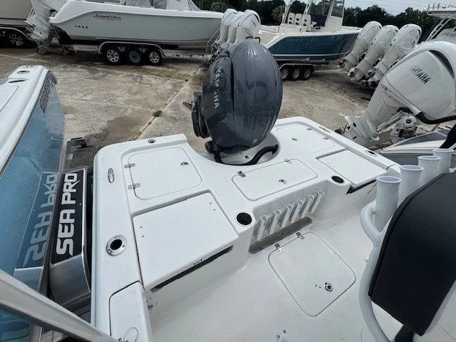 Slide: The Image of 2026 Sea Pro 210DLX boat with outboard motor in a parking lot. - 4