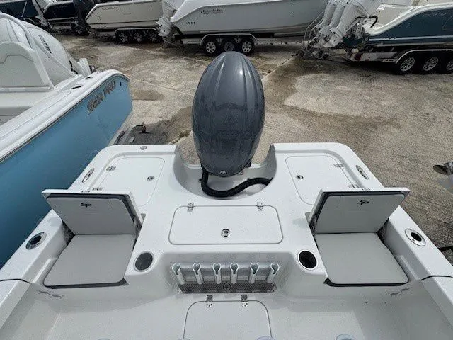Slide: The Image of Rear view of a 2026 Sea Pro 210DLX boat in a parking lot. - 6