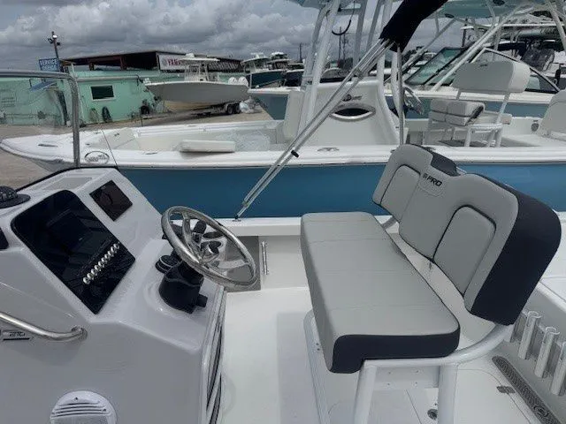 Slide: The Image of Interior view of a 2026 Sea Pro 210DLX boat with steering console. - 7