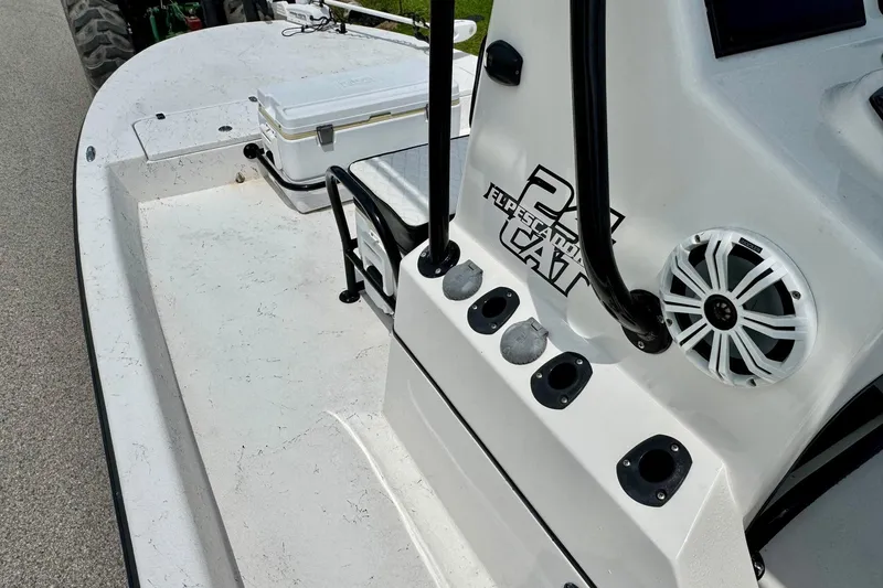 Slide: The Image of 2022 El Pescador 24 CAT boat interior with rod holders and storage. - 11