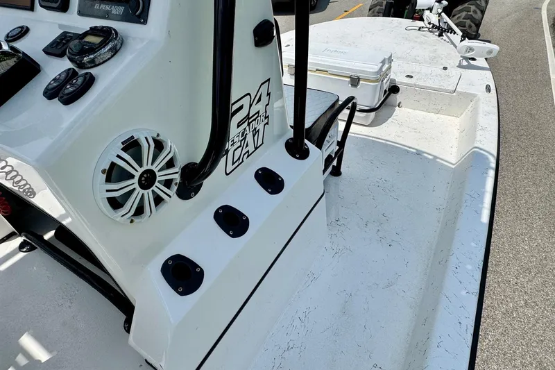 Slide: The Image of 2022 El Pescador 24 CAT boat interior with control panel and seating area. - 13