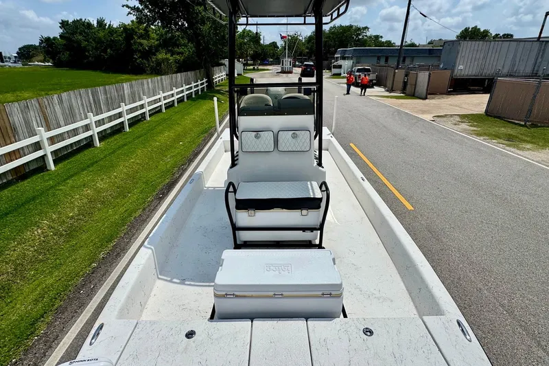Slide: The Image of 2022 El Pescador 24 CAT boat on road, showcasing spacious deck and seating. - 14