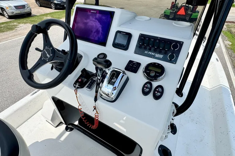 Slide: The Image of 2022 El Pescador 24 CAT boat dashboard with steering wheel and control panel. - 15