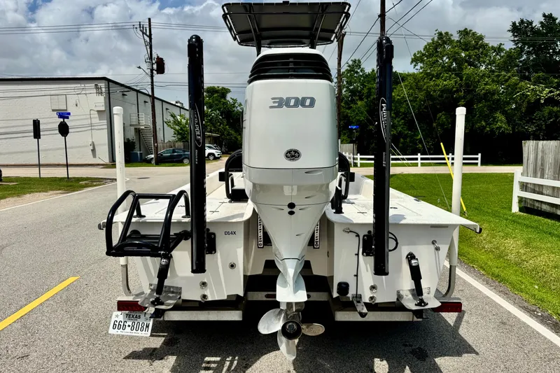 Slide: The Image of 2022 El Pescador 24 CAT boat with powerful 300 HP engine, parked on street. - 3