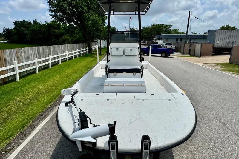 Slide: The Image of 2022 El Pescador 24 CAT boat on road, featuring spacious deck and modern design. - 6