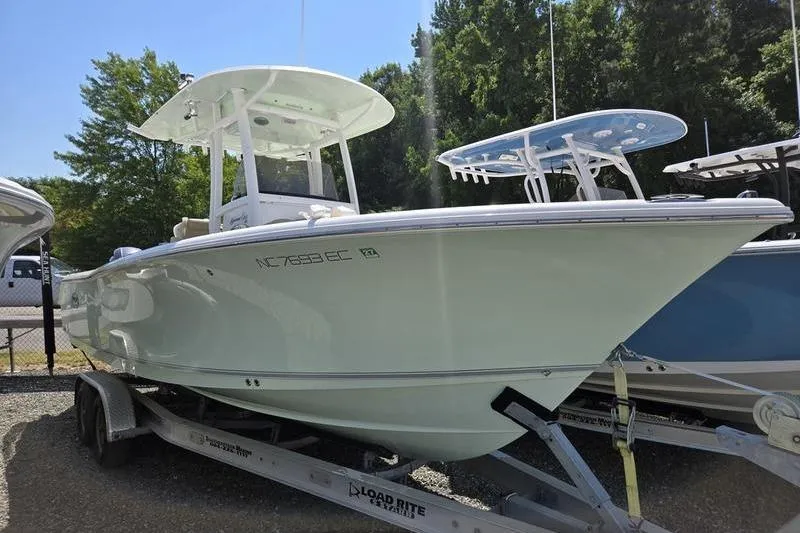 The Image of 2016 Sea Hunt Gamefish 25 boat on trailer, parked outdoors. - 0