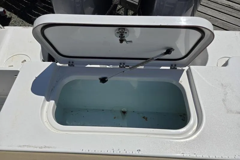 Slide: The Image of Open storage compartment on 2016 Sea Hunt Gamefish 25 boat. - 1
