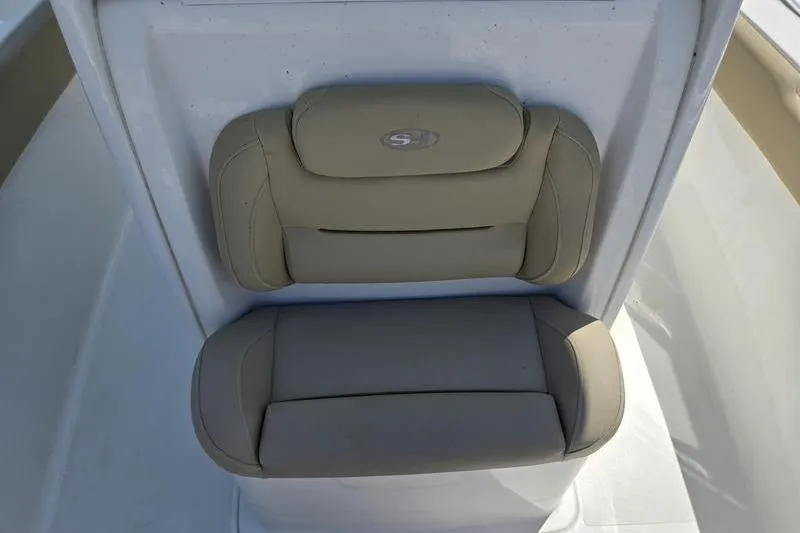 Slide: The Image of 2016 Sea Hunt Gamefish 25 boat seat with beige cushions and logo. - 13