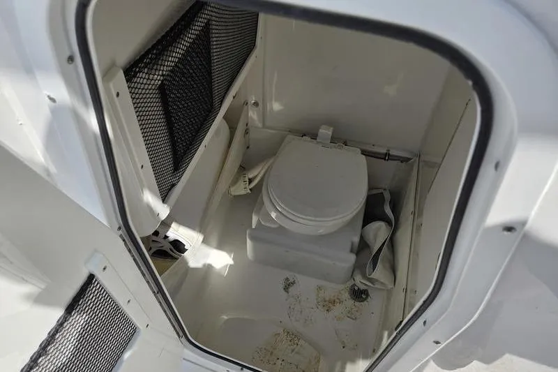 Slide: The Image of Interior view of a 2016 Sea Hunt Gamefish 25 boat's compact marine toilet. - 14