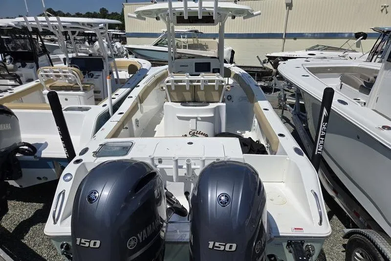 Slide: The Image of 2016 Sea Hunt Gamefish 25 boat with dual Yamaha 150 engines, docked in a marina. - 18