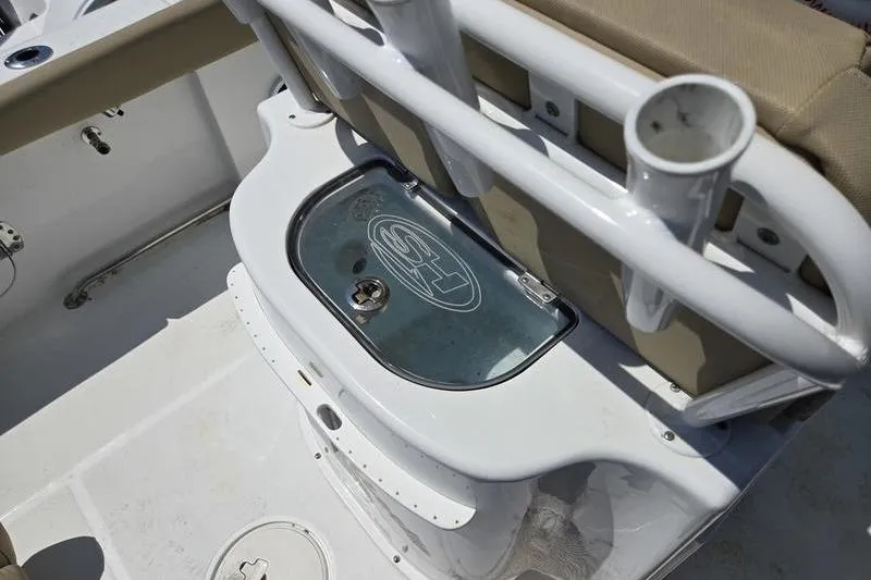 Slide: The Image of 2016 Sea Hunt Gamefish 25 boat interior with rod holders and storage compartment. - 5