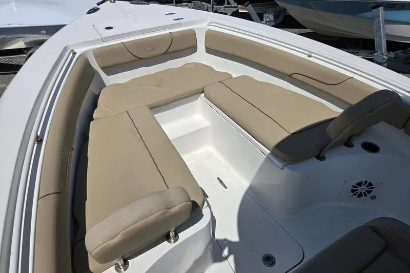 Slide: The Image of 2016 Sea Hunt Gamefish 25 boat interior with beige cushioned seating. - 6