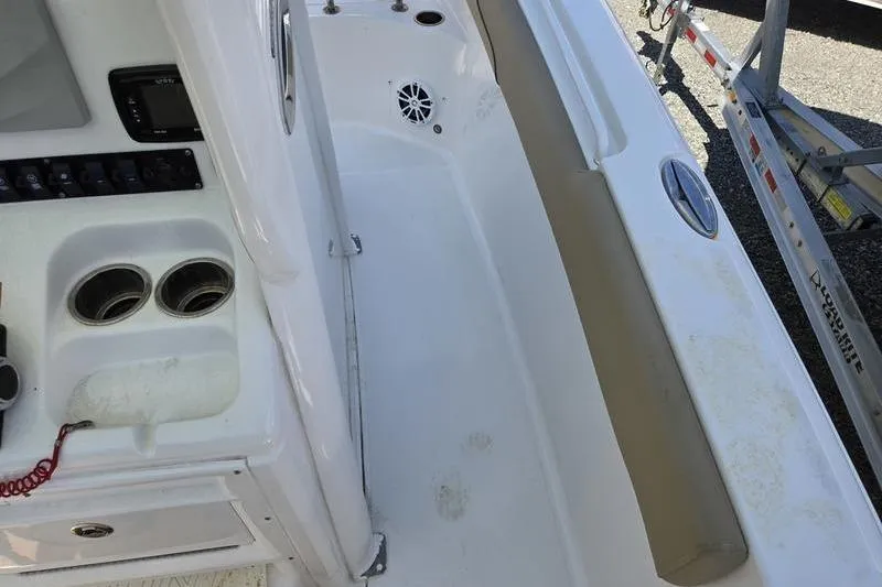 Slide: The Image of 2016 Sea Hunt Gamefish 25 boat interior with cup holders and control panel. - 8