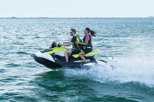 Slide: The Image of Manufacturer Provided Image: 2023 Sea-Doo Spark 2up jet ski with two riders on open water. - 2