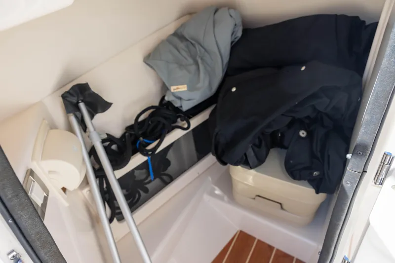 Slide: The Image of Storage compartment in a 2018 Grady-White Freedom 215 boat with gear and equipment. - 10