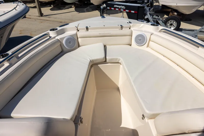 Slide: The Image of 2018 Grady-White Freedom 215 boat interior with cushioned seating and speakers. - 11