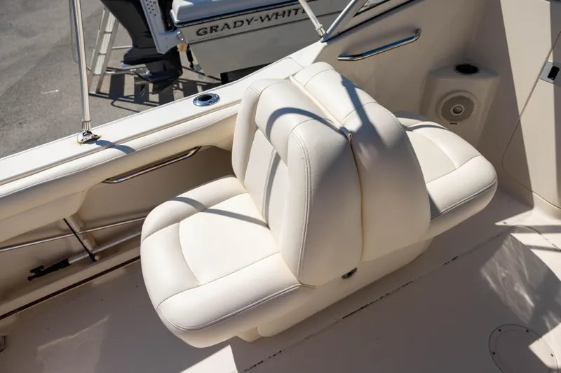 Slide: The Image of 2018 Grady-White Freedom 215 boat interior with white seating and speaker. - 17
