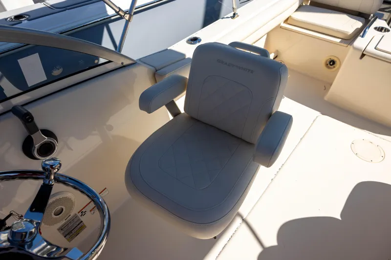 Slide: The Image of Captain's seat on 2018 Grady-White Freedom 215 boat, featuring luxurious upholstery and steering wheel. - 7