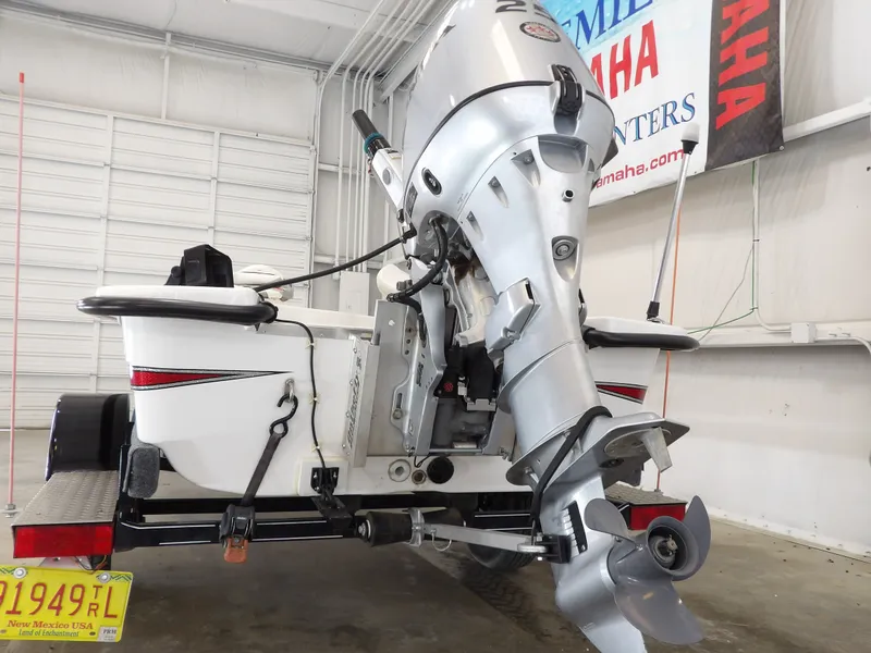 Slide: The Image of 2017 Bass Cat Phelix boat with outboard motor in a garage. - 11
