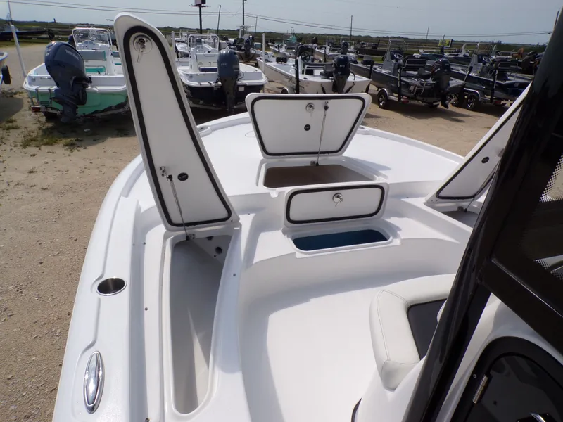 Slide: The Image of 2026 Tidewater 2210 Carolina Bay with open storage compartments at the dock. - 27