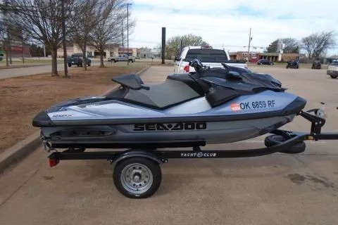 The Image of 2024 Sea-Doo RXP-X 325 jet ski on trailer in parking lot. - 0