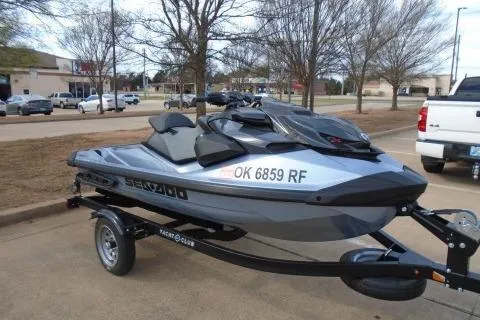 Slide: The Image of 2024 Sea-Doo RXP-X 325 jet ski on trailer in parking lot. - 1