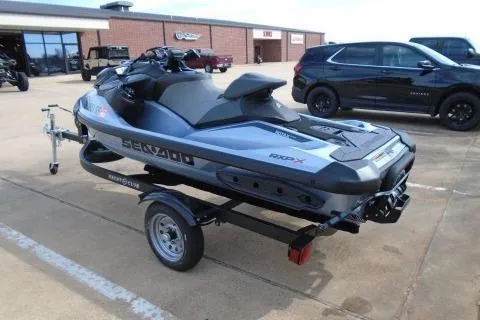 Slide: The Image of 2024 Sea-Doo RXP-X 325 jet ski on trailer, parked outdoors. - 5