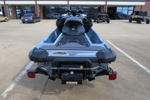 Slide: The Image of 2024 Sea-Doo RXP-X 325 jet ski, rear view in a parking lot. - 6