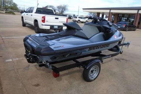 Slide: The Image of 2024 Sea-Doo RXP-X 325 jet ski on trailer in parking lot. - 7