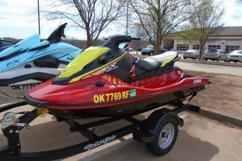 The Image of 2024 Yamaha WaveRunner EX Deluxe in red on a trailer, parked outdoors. - 0