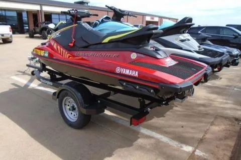 Slide: The Image of 2024 Yamaha WaveRunner EX Deluxe on trailer, parked outdoors. - 2
