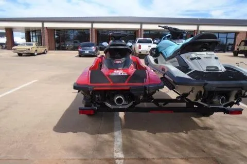 Slide: The Image of 2024 Yamaha WaveRunner EX Deluxe jet skis on trailer in parking lot. - 3