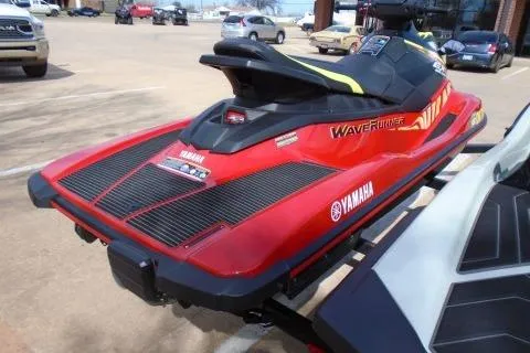 Slide: The Image of 2024 Yamaha WaveRunner EX Deluxe in vibrant red, parked on a trailer. - 4