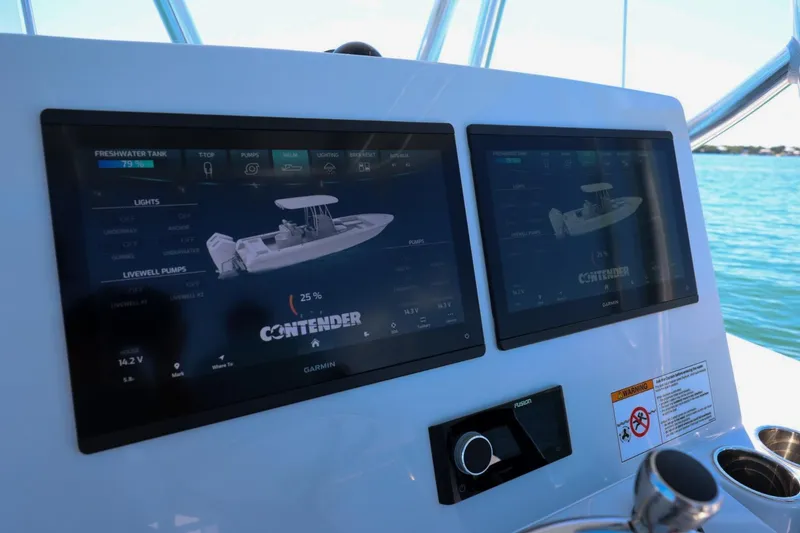 Slide: The Image of Dashboard of 2026 Contender 29 Bay boat with dual Garmin displays on water. - 12