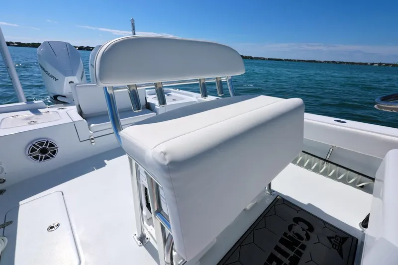 Slide: The Image of 2026 Contender 29 Bay boat interior with white seating and ocean backdrop. - 13