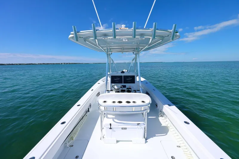 Slide: The Image of 2026 Contender 29 Bay boat on calm ocean waters under clear blue sky. - 15
