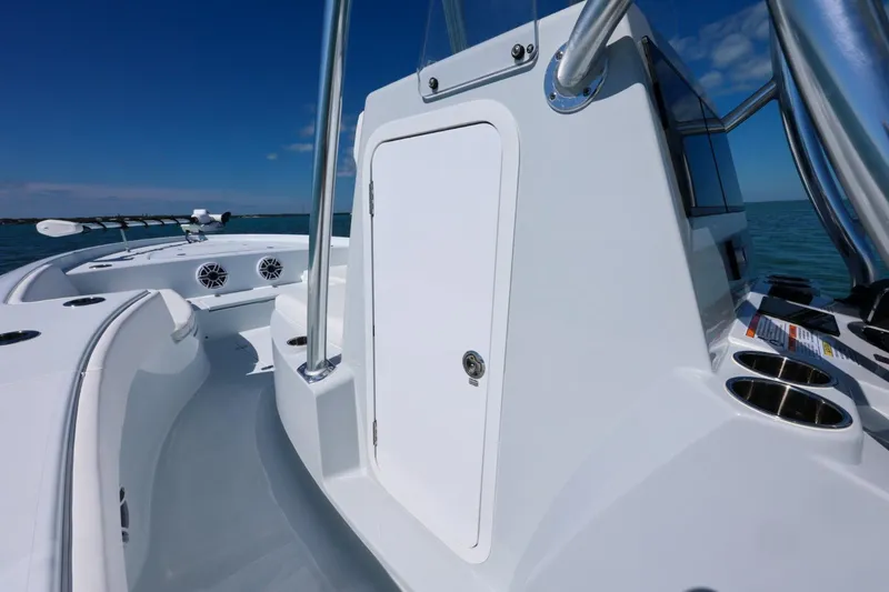 Slide: The Image of 2026 Contender 29 Bay boat, sleek design, white exterior, ocean backdrop. - 18