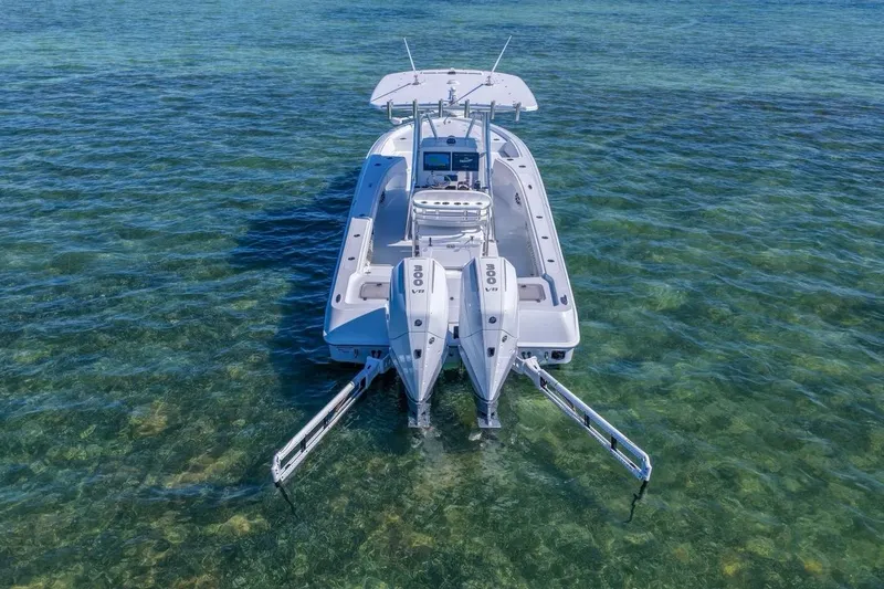 Slide: The Image of 2026 Contender 29 Bay boat with dual engines on clear water. - 20