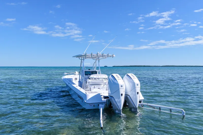 Slide: The Image of 2026 Contender 29 Bay boat with dual engines on clear blue water. - 3