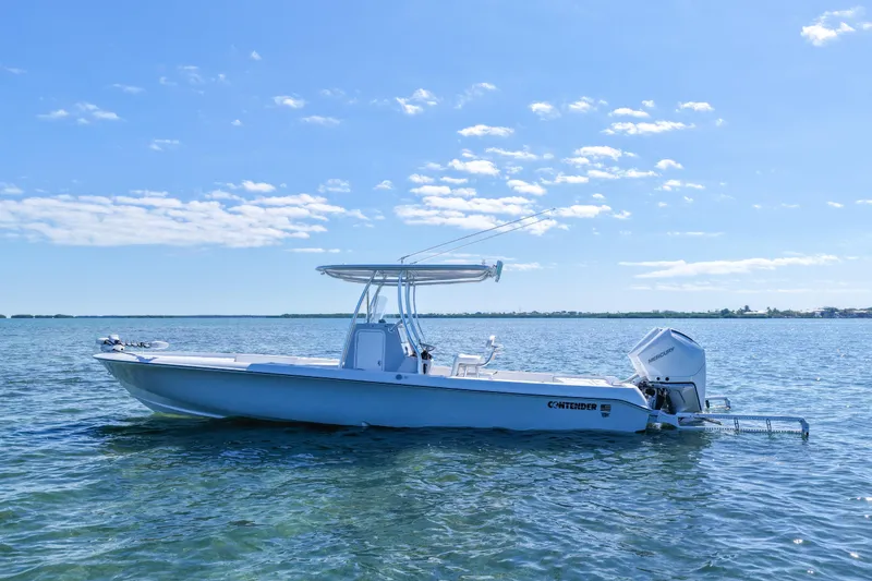 Slide: The Image of 2026 Contender 29 Bay boat on calm water under clear blue sky. - 4