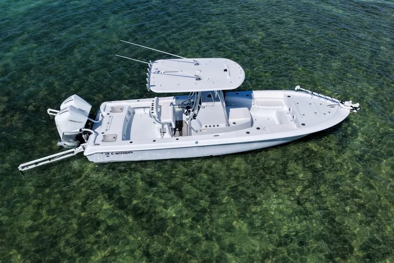 Slide: The Image of 2026 Contender 29 Bay boat on clear water, showcasing sleek design and powerful engine. - 6